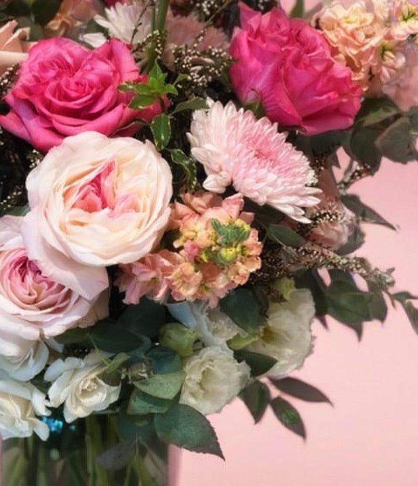 a close-up of a pink & peach garden-style vased floral arrangement