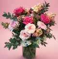 a full image of a pink&peach garden-style floral arrangement in a vase